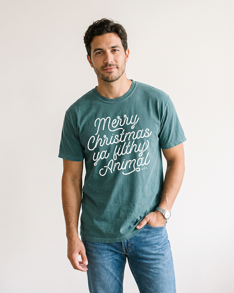 Man wearing Blue Spruce Merry Christmas Ya Filthy Animal Christmas tee