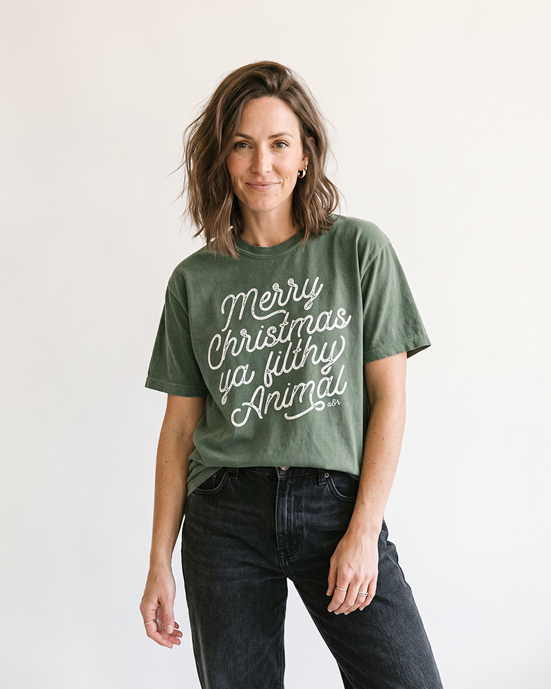 Woman wearing hemp Merry Christmas Ya Filthy Animal heavyweight tee