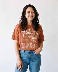 Woman wearing yam orange Midnight Margaritas vintage witchy t-shirt