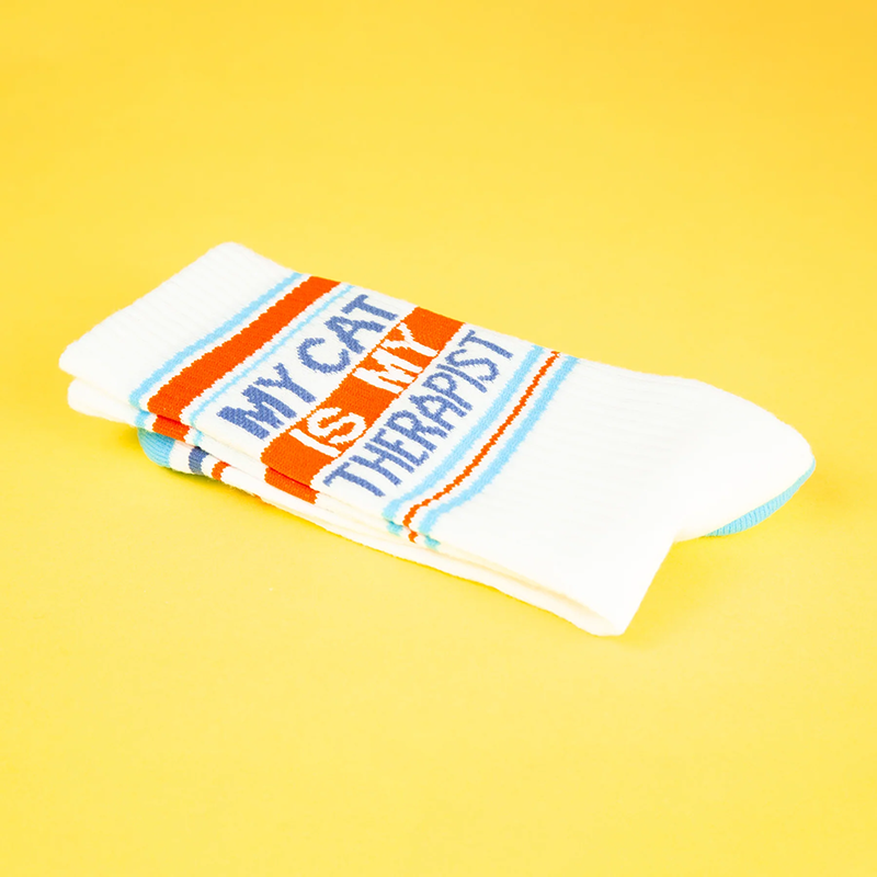 Folded My Cat Is My Therapist cat lover socks featuring blue lettering and orange striped design