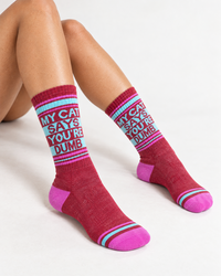 Model wearing My Cat Says You're Dumb crew socks with crimson berry knit and contrasting pink toes