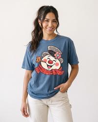 Woman wearing a Denim blue Retro Frosty Snowman Christmas heavyweight tee with oversized vintage snowman graphic.