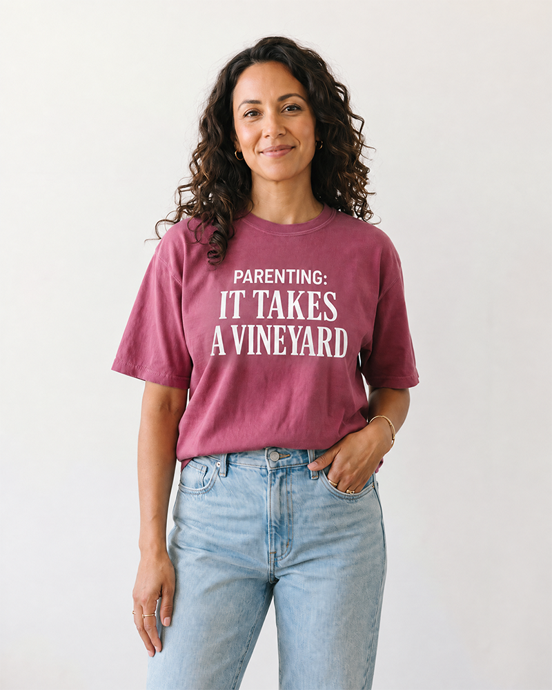 Woman wearing berry Parenting It Takes a Vineyard motherhood t-shirt