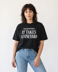 Woman wearing black Parenting It Takes a Vineyard funny mom t-shirt
