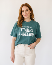 Woman wearing blue spruce Parenting It Takes a Vineyard funny mom t-shirt