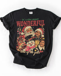 Black Comfort Colors Christmas graphic T-shirt with vintage holiday characters and It's the Most Wonderful Time of the Year lettering.