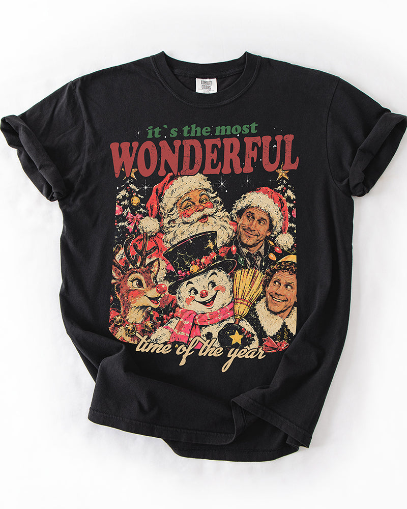 Black Comfort Colors Christmas graphic T-shirt with vintage holiday characters and It's the Most Wonderful Time of the Year lettering.