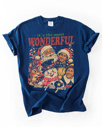 True Navy heavyweight Christmas graphic tee featuring a retro collage of Santa, Rudolph, a snowman, and holiday movie characters.