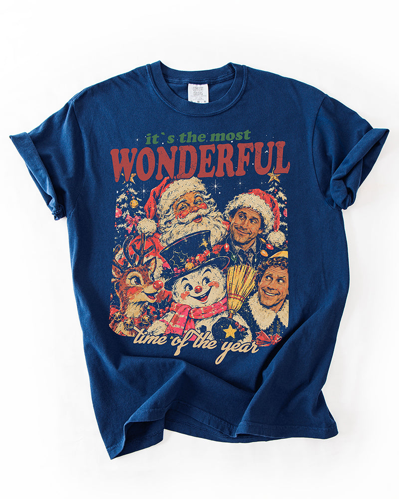 True Navy heavyweight Christmas graphic tee featuring a retro collage of Santa, Rudolph, a snowman, and holiday movie characters.