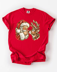 Red Comfort Colors heavyweight Christmas T-shirt featuring a nostalgic Santa and reindeer nose boop illustration.