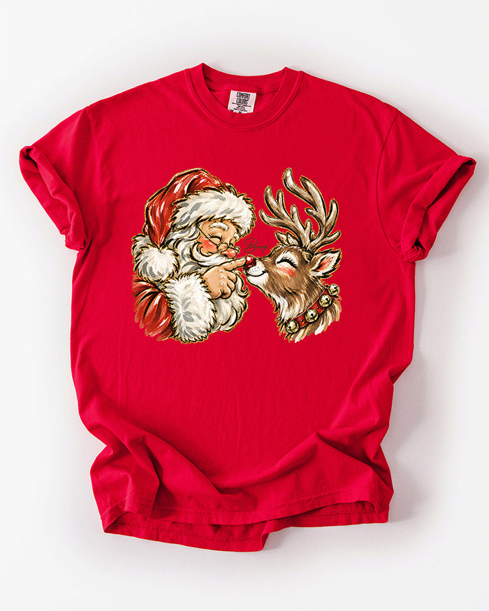 Red Comfort Colors heavyweight Christmas T-shirt featuring a nostalgic Santa and reindeer nose boop illustration.