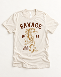 Savage Wild & Free tiger graphic tee in a warm neutral color with vintage-inspired brown and golden tiger artwork