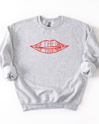Ash gray Save The Drama For Your Mama crewneck sweatshirt with red lips lettering graphic and rolled sleeves.