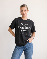 Woman wearing Black Slow Mornings Club heavyweight graphic tee