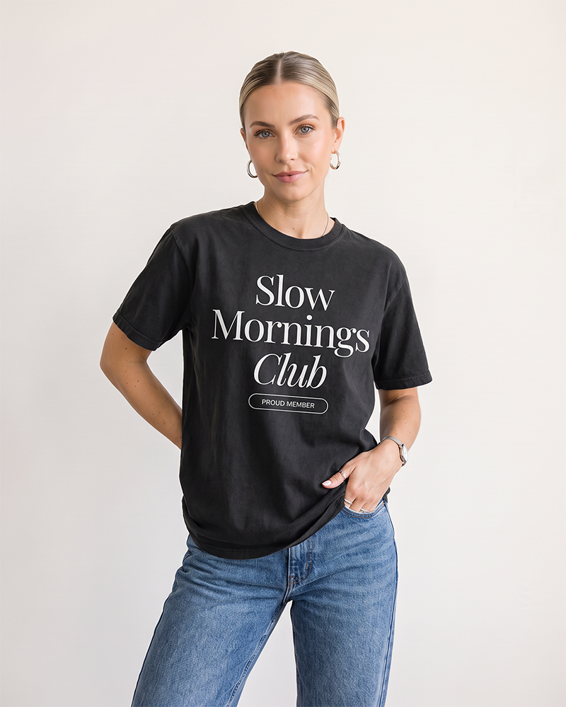 Woman wearing Black Slow Mornings Club heavyweight graphic tee