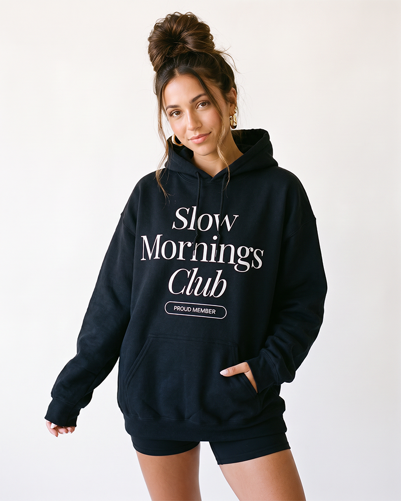 Woman wearing black Slow Mornings Club graphic hoodie