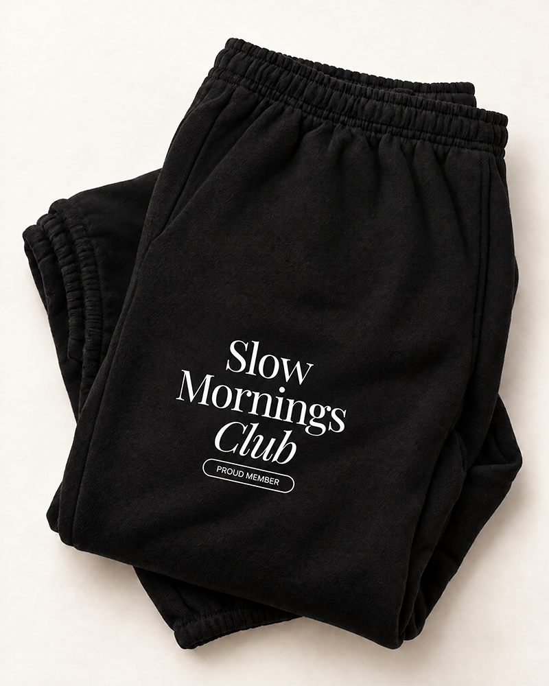 Black Slow Mornings Club sweatpants with white thigh graphic