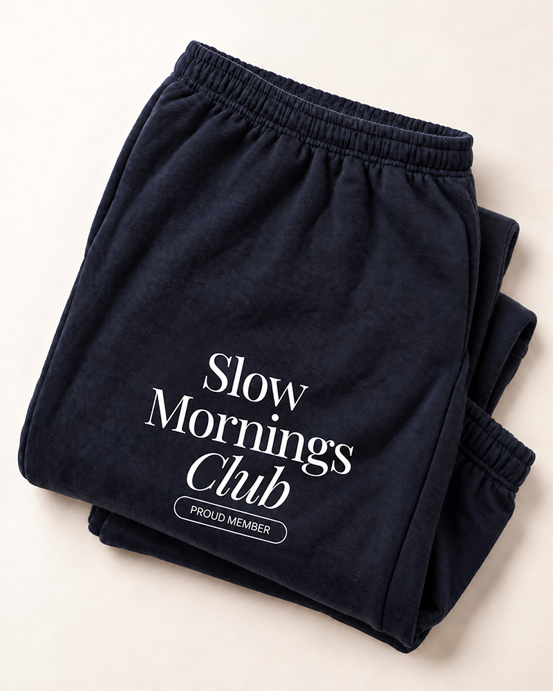 Navy Slow Mornings Club sweatpants with white thigh graphic