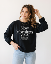 Woman wearing Black Slow Mornings Club crewneck sweatshirt