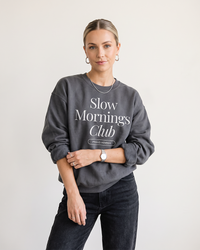Woman wearing Charcoal Slow Mornings Club crewneck sweatshirt