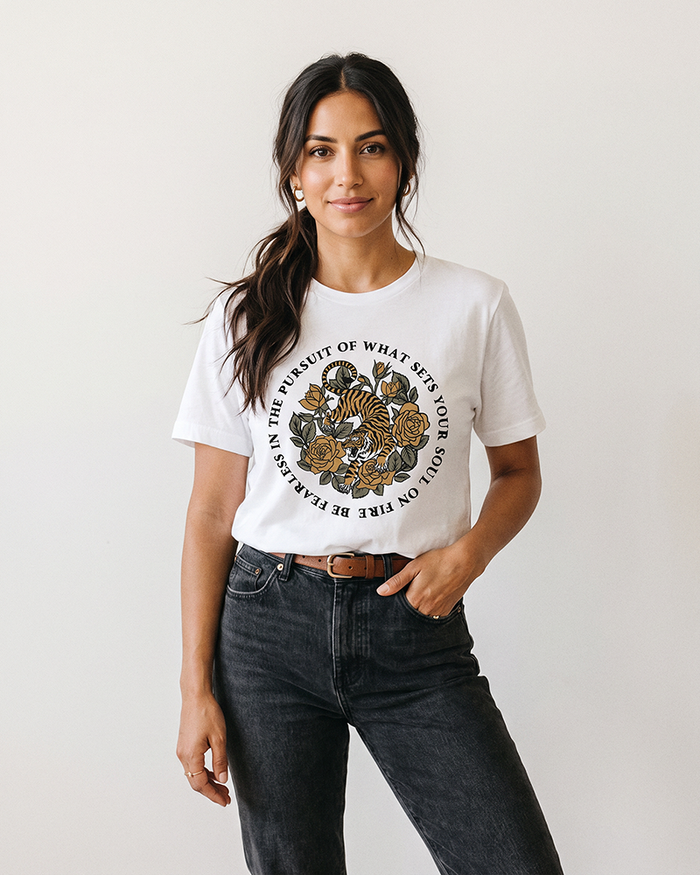 Woman wearing white Soul on Fire tiger and rose graphic tee with black jeans