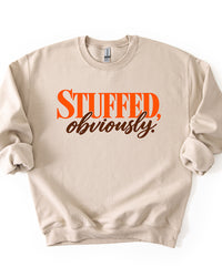 Sand beige Stuffed, Obviously Thanksgiving sweatshirt with retro orange and brown typography graphic.