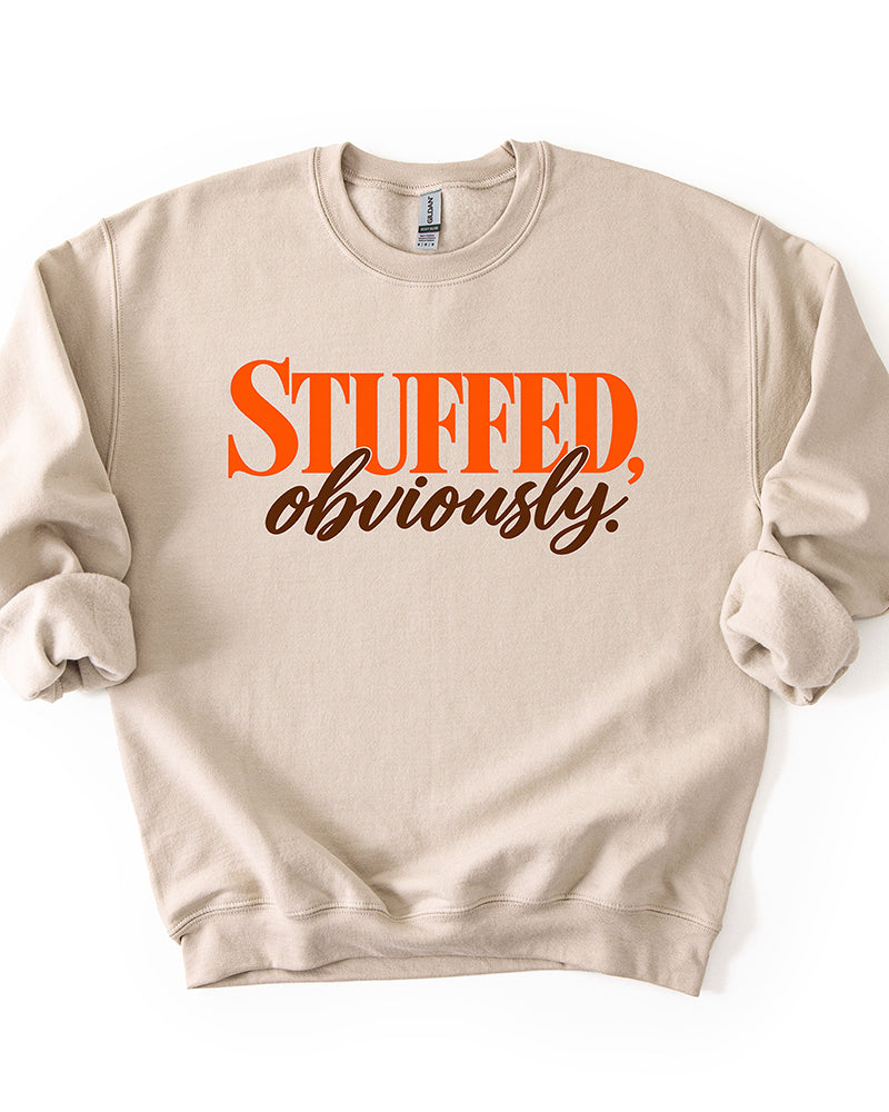 Sand beige Stuffed, Obviously Thanksgiving sweatshirt with retro orange and brown typography graphic.
