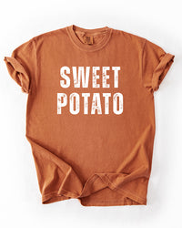 Yam orange Comfort Colors heavyweight T-shirt with distressed white Sweet Potato lettering and rolled sleeves.