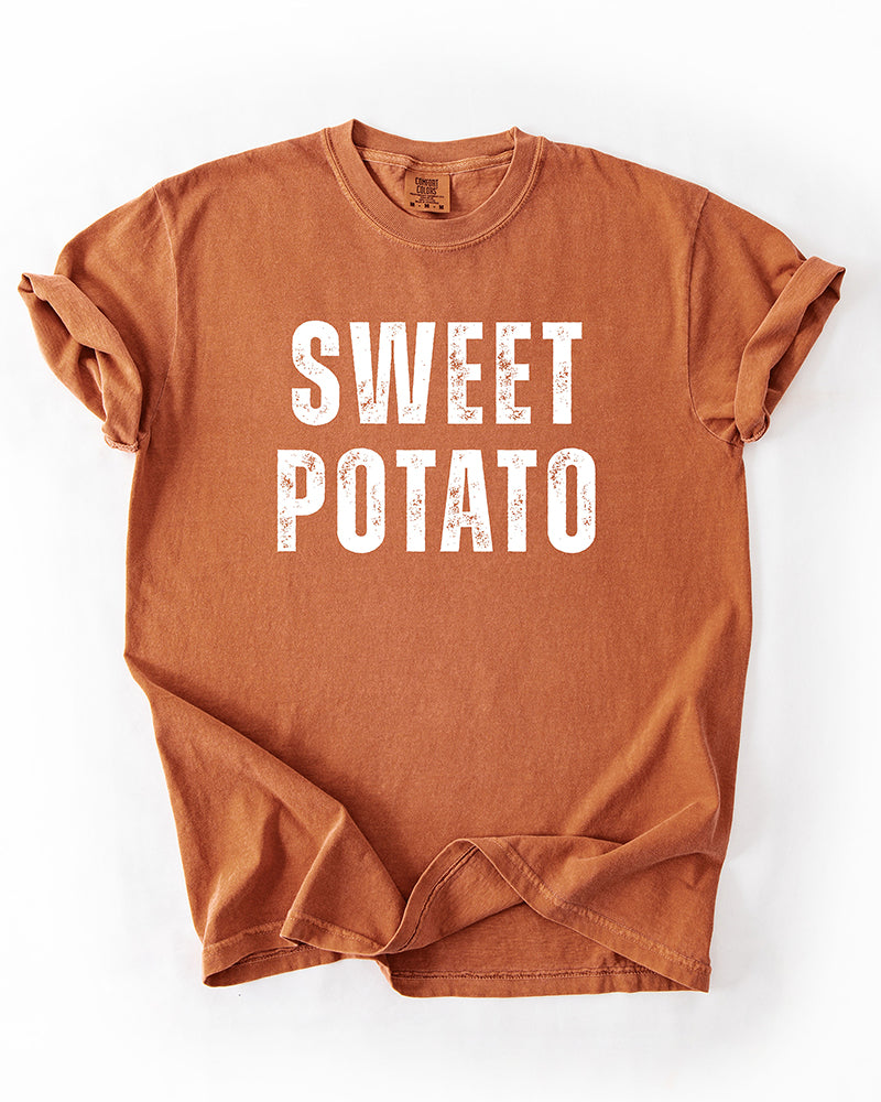 Yam orange Comfort Colors heavyweight T-shirt with distressed white Sweet Potato lettering and rolled sleeves.