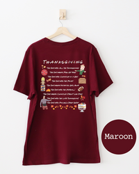 Back of maroon Thanksgiving graphic T-shirt with illustrated references to iconic Friends Thanksgiving episodes.