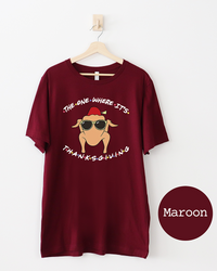 Maroon Friends Thanksgiving graphic tee featuring a cartoon turkey with sunglasses and fez surrounded by The One Where It's Thanksgiving lettering.