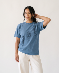 Woman wearing Blue Jean Comfort Colors tiger graphic tee with cream pants