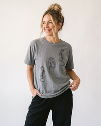 Woman wearing grey heavyweight tiger graphic t-shirt with black pants
