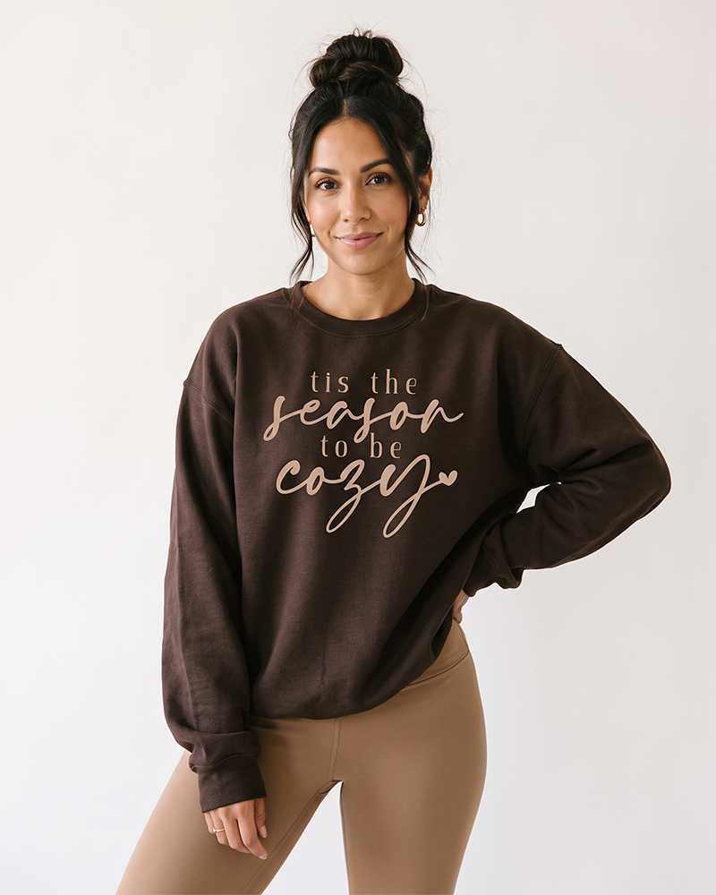 Woman wearing dark chocolate Tis the Season to Be Cozy fall sweatshirt
