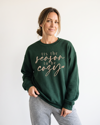 Woman wearing forest green Tis the Season to Be Cozy sweatshirt