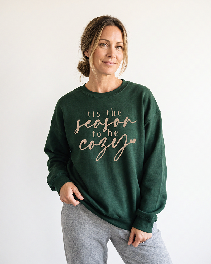 Woman wearing forest green Tis the Season to Be Cozy sweatshirt