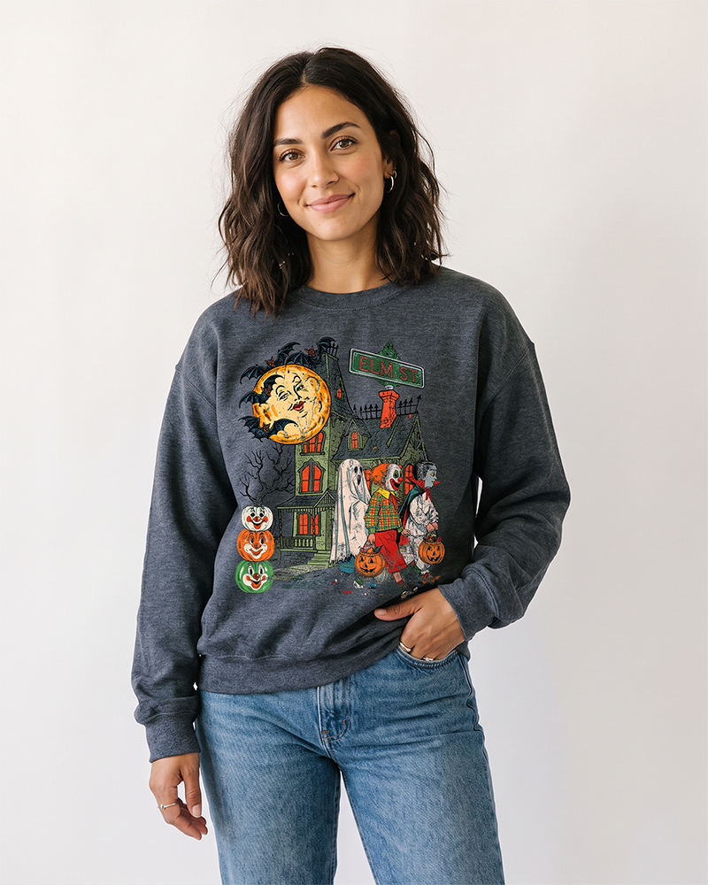 Woman wearing dark heather grey vintage Halloween sweatshirt with Elm St haunted house graphic
