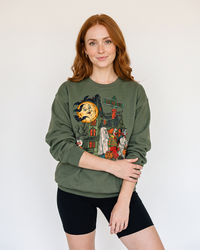 Woman wearing military green vintage trick or treat Halloween crewneck sweatshirt