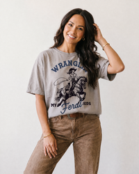 Western mom wearing grey Wranglin My Feral Kids heavyweight tee with vintage cowgirl graphic